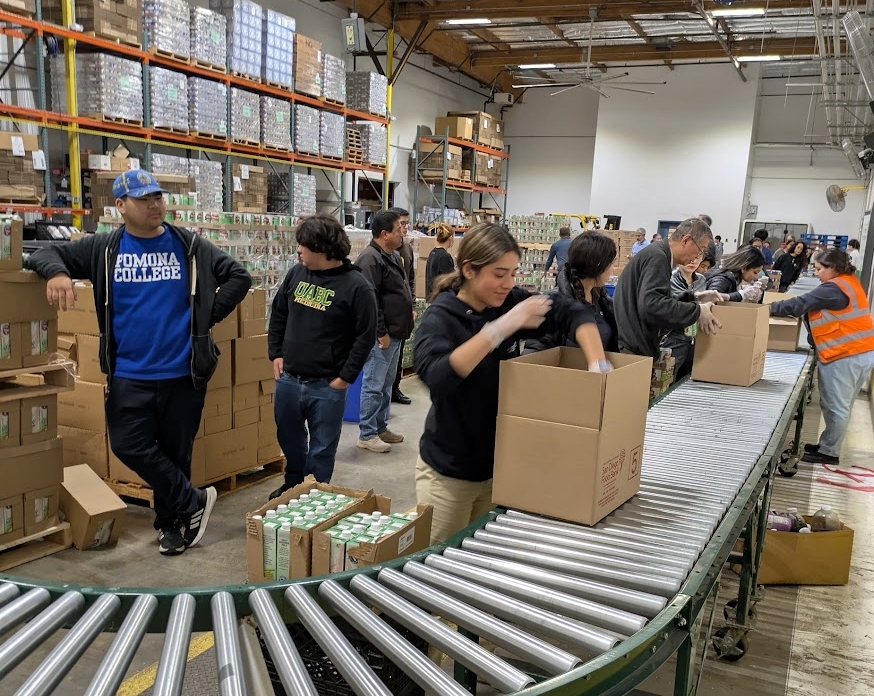 Cristo Rey San Diego students packing boxes at a food bank